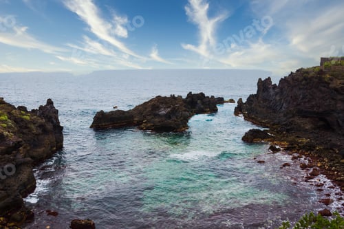 Preview: the ocean looks small but calm during the day with blue sky