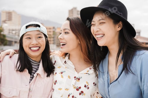 Preview: Happy asian girls having fun together outdoor around city - Main focus on center woman face