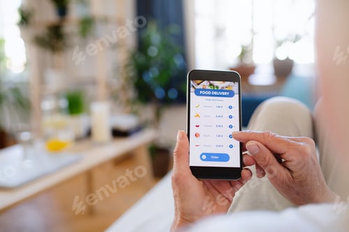 Preview: Unrecognizable woman with smartphone indoors at home, ordering food