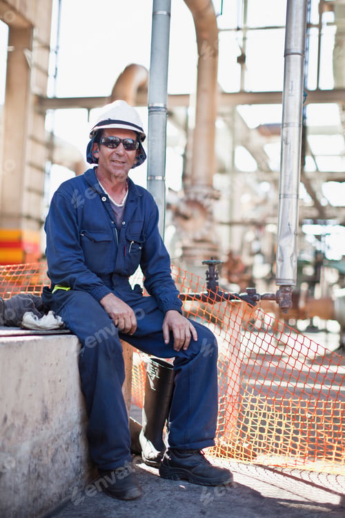 Preview: Worker sitting at oil refinery