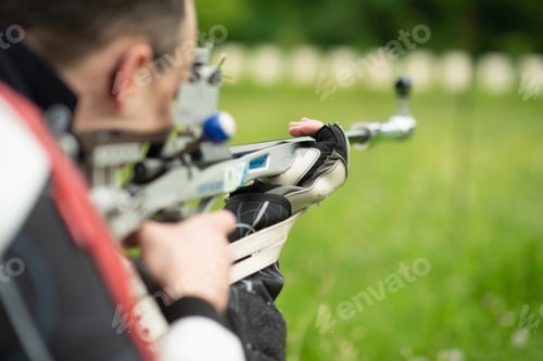 Preview: A determined male athlete practices for an upcoming competition with a free rifle