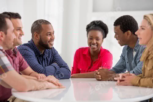 Preview: A group of four people, two men and two women seated talking.