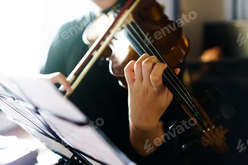 Preview: Close up woman playing violin in front of black background