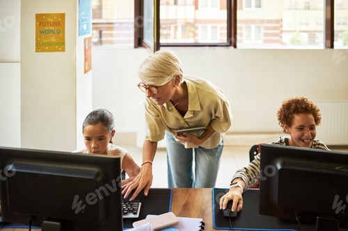 Preview: Middle Aged Caucasian Woman Teaching Diverse Children Using Desktop Computers