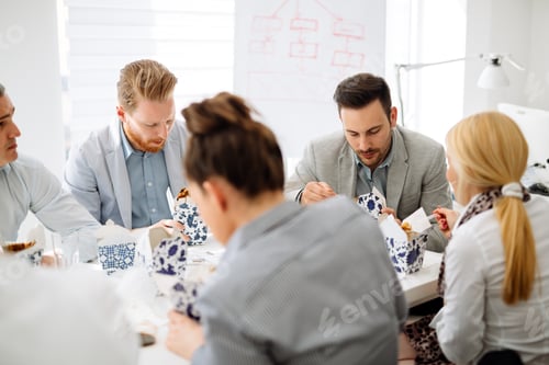 Preview: Colleagues eating in office
