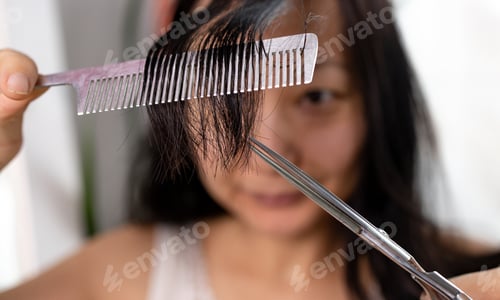 Preview: Satisfaction lifestyle stay at home concept. Young adult authentic asian woman self cutting bangs ha