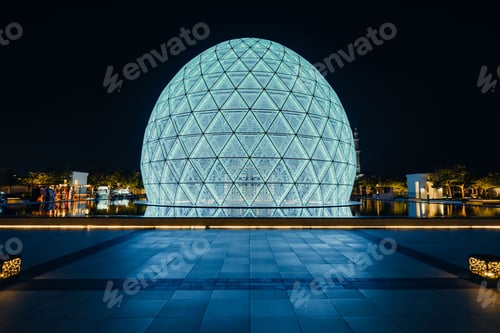 Preview: Scenic view of a round modern building illuminated at night in Abu Dhabi, UAE