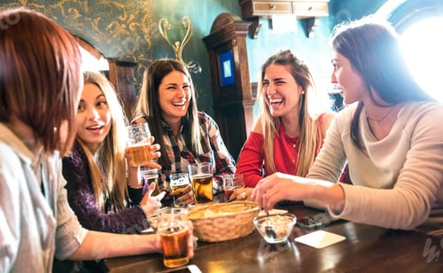 Preview: Happy women drinking beer at brewery restaurant