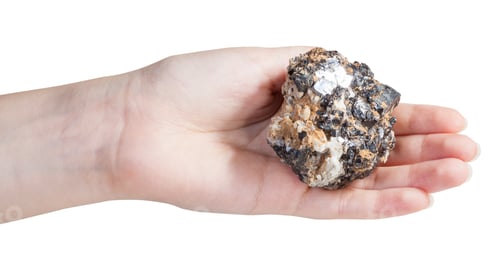 Preview: piece of zinc and lead mineral ore on female palm