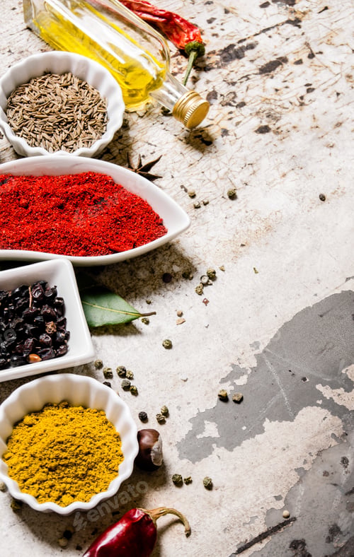Preview: Set of colorful spices and herbs. On rustic background.