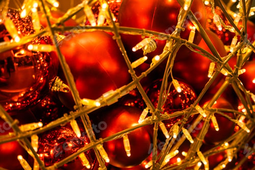Preview: Red glowing Christmas balls garlands close-up. Holidays decoration and festive xmas concept. Copy