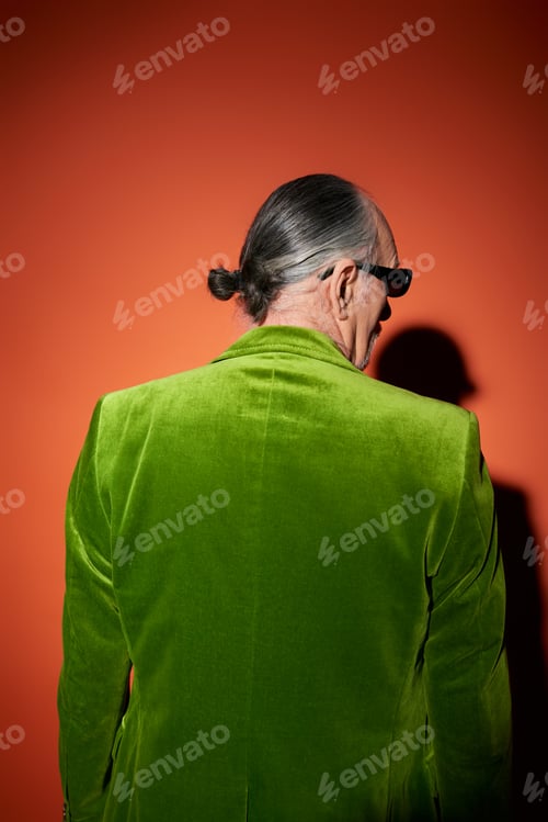 Preview: back view of grey haired senior man in trendy casual clothes, green velour blazer and dark