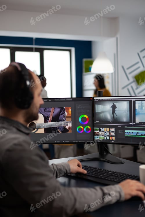 Preview: Videographer listening music on headphones editing creativity movie using post production software