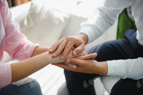 Preview: Close-up of the psychiatrist's hand holding the patient's hand.