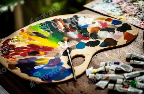 Preview: Colorful Paint Palette with Brush on Wooden Table