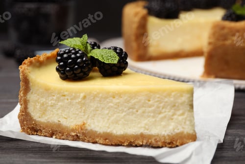 Preview: Piece of delicious cheesecake decorated with blackberries on table