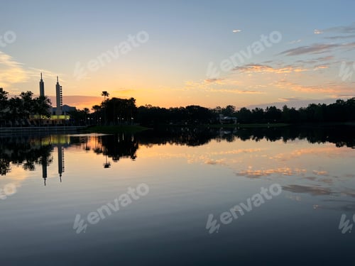 Preview: reflections of the town on the lake water at sunrise