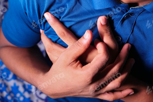Preview: young man suffering heart and holding his chest.