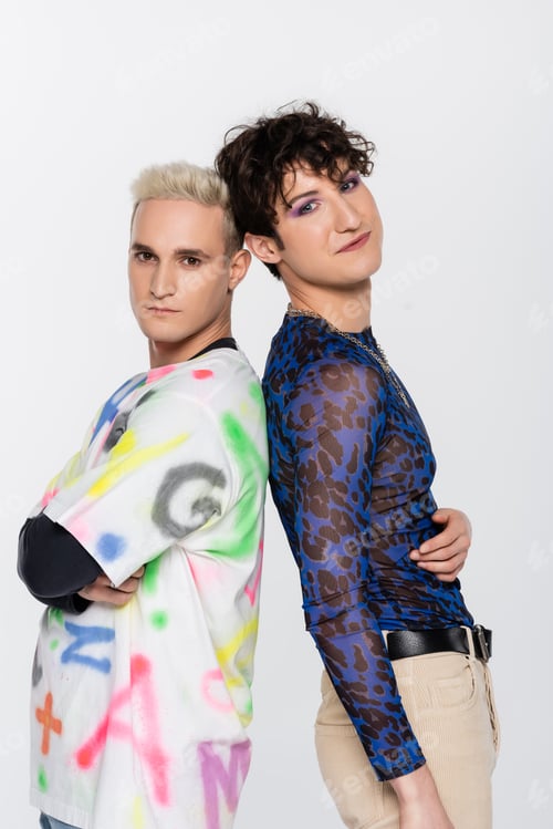 Preview: blonde gay man and brunette nonbinary person in stylish clothes standing back to back isolated on