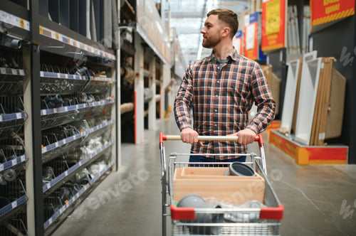 Preview: Portrait of happy mature man standing in hardware store