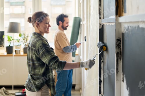 Preview: Couple painting walls of living room