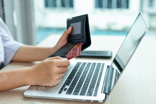 Preview: Business women hold credit cards To put information on the card to make payment via card, electronic
