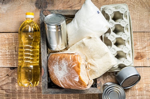Preview: Wooden box with Donation food, quarantine help concept. Oil, canned food, pasta, bread, sugar, egg.