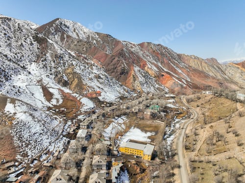 Preview: Aerial view of Ming-Kush village surrounded by snow-dusted, colorful mountains