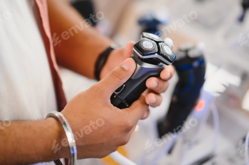 Preview: Indian Man choosing trimmer at electric store