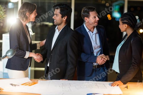 Preview: Group Of Businesspeople Shaking Hands With Each Other In The Office