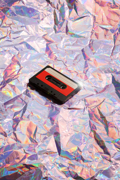 Preview: old cassette tape on crumpled pink background. retro and nostalgia style. vintage music concept.