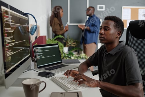 Preview: Programmer at Work in Modern Office