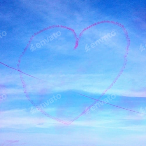 Preview: Trail of red smoke in the shape of a heart from an airplane on a blue sky