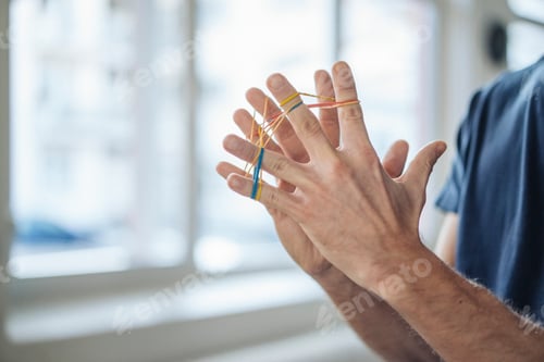 Preview: Close-up of man holding rubber bands