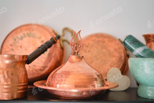 Preview: Traditional copper Turkish utensils on a shelf in the kitchen at home or in a restaurant