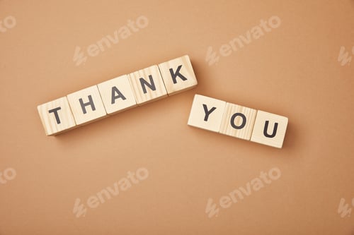 Preview: top view of wooden blocks with thank you lettering on beige background