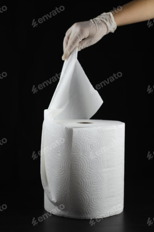Preview: Vertical shot of a person with gloves holding a tissue isolated on a black background