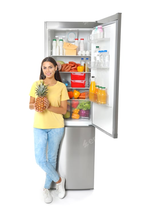 Preview: Young woman with pineapple near open refrigerator on white background