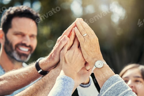 Preview: Shot of a family giving each other a high five in the garden at home