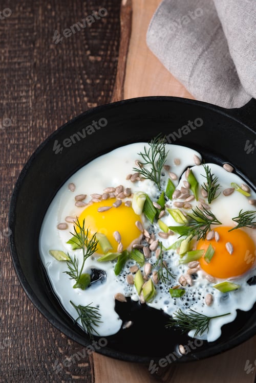 Preview: Scrambled eggs on the wooden table vertical