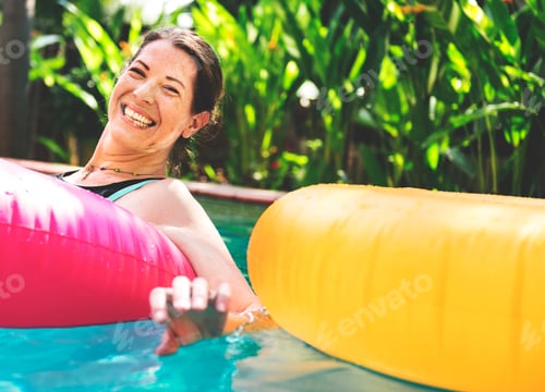 Preview: Woman enjoying the water in a swimming pool