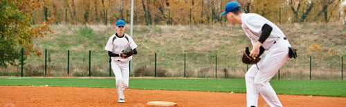 Preview: Teenage boys enjoy a spirited game of baseball in a vibrant autumn field