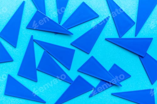 Preview: Blue plastic flat triangles are scattered chaotically on a blue background.