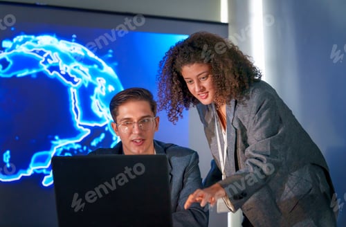 Preview: Team members collaborating in an office with a digital world map on display