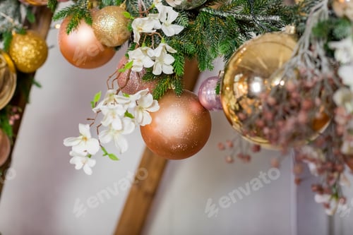 Preview: Christmas decorations, golden, orange balls hanging on wooden decor frame. winter holiday atmosphere