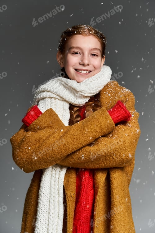 Preview: Smiling child in cozy winter attire enjoying snowflakes in a joyful outdoor setting