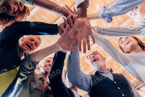 Preview: team of diverse people in it as one - group of businesspeople joining their hands in solidarity
