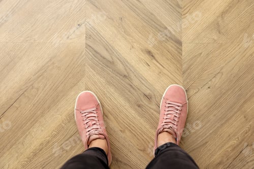 Preview: Woman standing on wooden floor, top view. Space for text