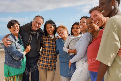 Preview: Group of multigenerational people hugging each other outdoor while smiling