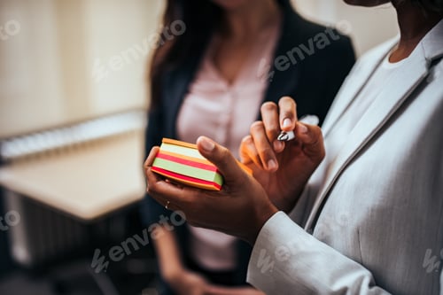 Preview: Business, ideas and people concept. Close-up of a woman with notes in hand, talking with co-worker.